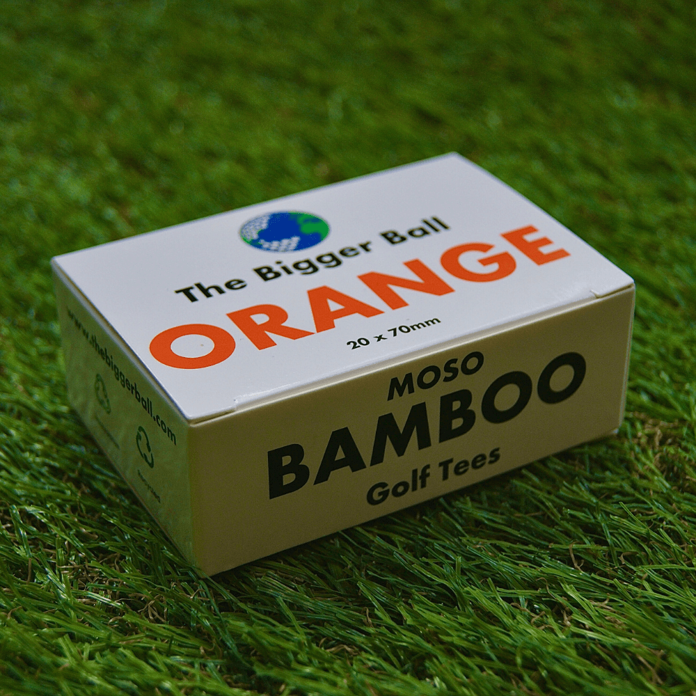 box of orange bamboo tees on astro grass